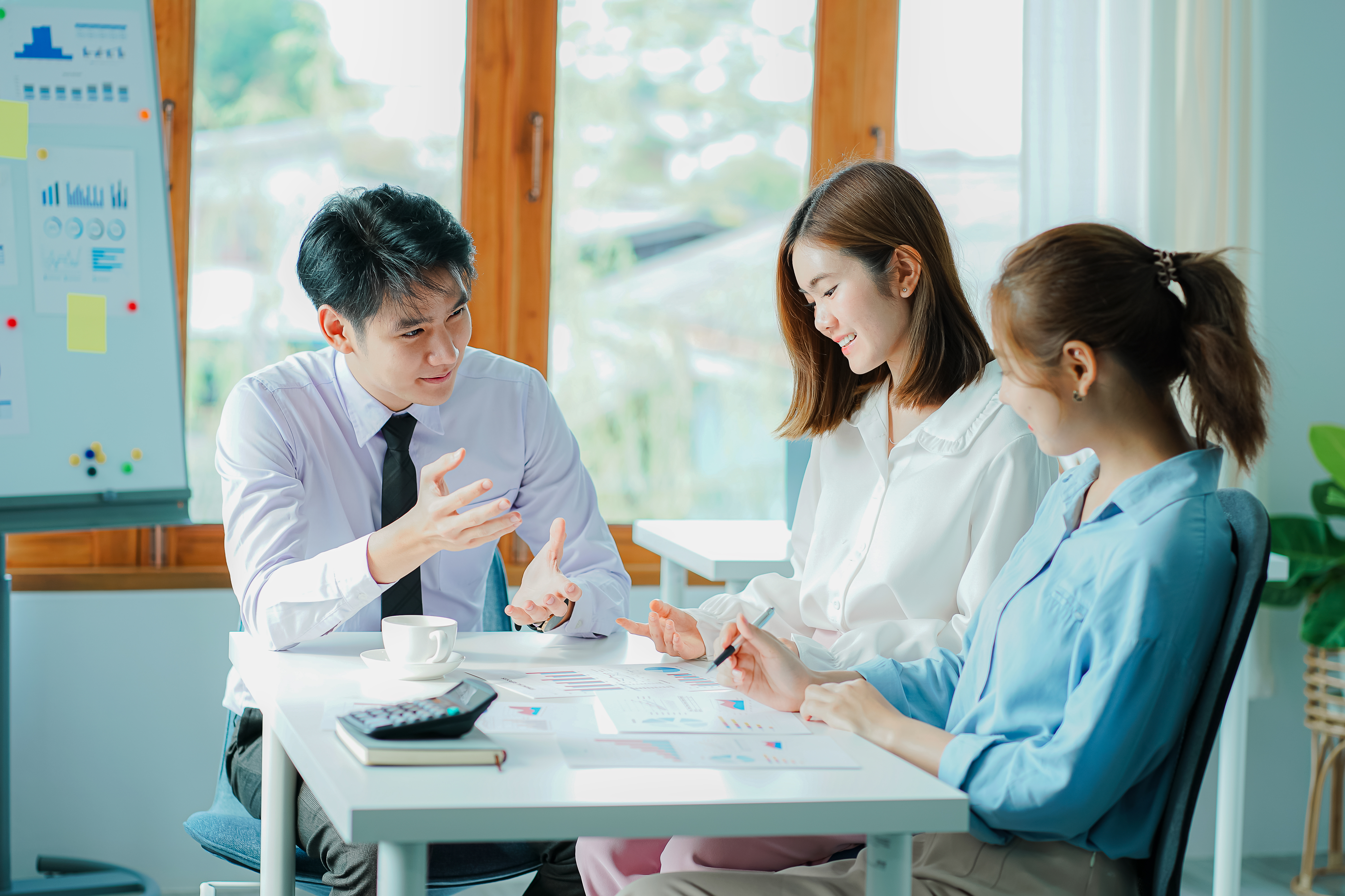 Three person seating in the chair while discussing somethng about business